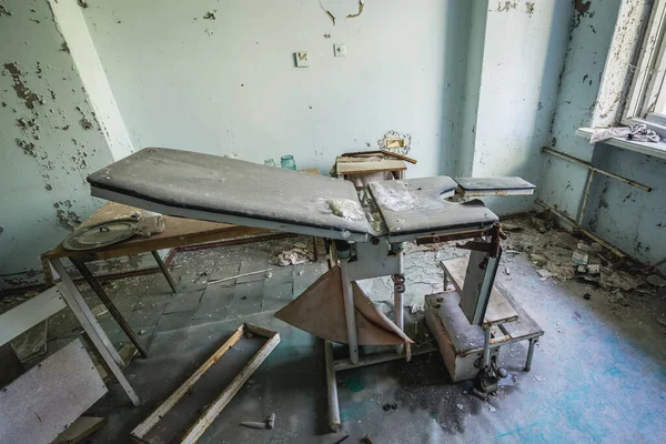 Examination bed in Hospital MsCh-126 in Pripyat ghost city in Chernobyl Exclusion Zone, Ukraine