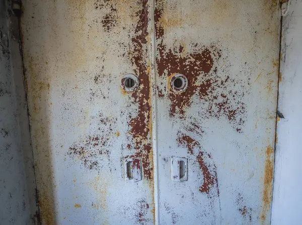 Rusty metal door in Hospital MsCh-126 in Pripyat ghost city in Chernobyl Exclusion Zone, Ukraine