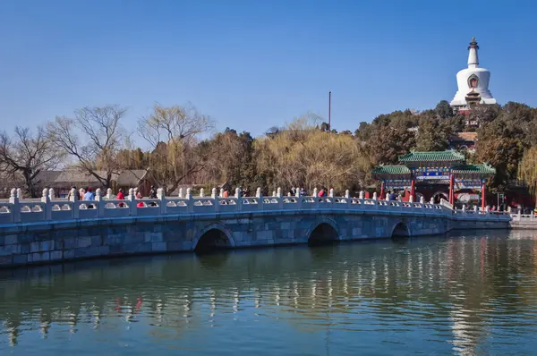 stock image Beijing, China - March 28, 2013: Yong'an bridge leading to Bai Ta White Pagoda or White Dagoba stupa in Beihai Park, Beijing