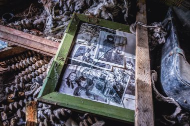 Chernobyl Zone, Ukraine - September 30, 2014: Photographs in old cottage in abandoned Stechanka village in Chernobyl Exclusion Zone clipart