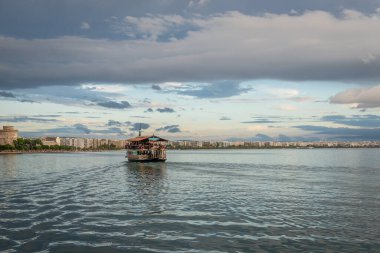 Thessaloniki, Greece - October 11, 2021: Pleasure boat on Aegean Sea seen from waterfront in Thessaloniki city, Greece clipart