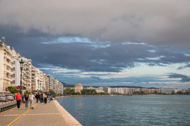 Thessaloniki, Greece - October 11, 2021: Promenade along Nikis Avenue in Thessaloniki city, Greece. White Tower on background clipart