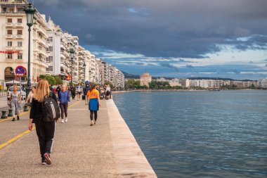 Thessaloniki, Greece - October 11, 2021: Promenade along Nikis Avenue in Thessaloniki city, Greece. White Tower on background clipart