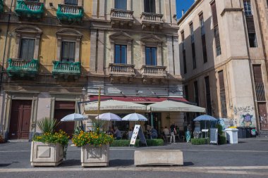 Catania, Italy - September 25, 2021: Cafeteria on Vincenzo Bellini Square in historic part of Catania city on the island of Sicily, Italy clipart