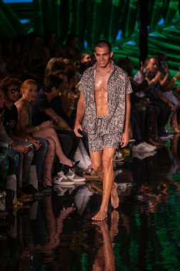 A model walks the runway for Berry Beachy Swimwear  Papi Swim Fashion Show during Art, Hearts, Fashion Swim Week at the Faena Forum in Miami Beach on 7- 11- 2021