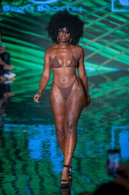 A model walks the runway for Berry Beachy Swimwear  Papi Swim Fashion Show during Art, Hearts, Fashion Swim Week at the Faena Forum in Miami Beach on 7- 11- 2021