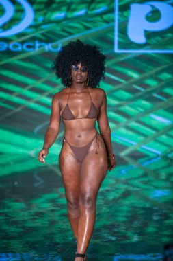 A model walks the runway for Berry Beachy Swimwear  Papi Swim Fashion Show during Art, Hearts, Fashion Swim Week at the Faena Forum in Miami Beach on 7- 11- 2021