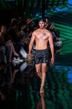A model walks the runway for Berry Beachy Swimwear  Papi Swim Fashion Show during Art, Hearts, Fashion Swim Week at the Faena Forum in Miami Beach on 7- 11- 2021
