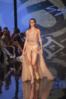 A model walks the runway for the House of Skye Sexy Black Bra Fashion Show during Art, Hearts, Fashion Swim Week at the Faena Forum in Miami Beach on 7- 11- 2021