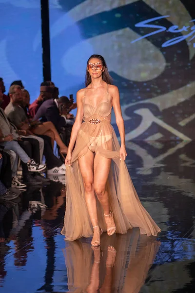 A model walks the runway for the House of Skye Sexy Black Bra Fashion Show during Art, Hearts, Fashion Swim Week at the Faena Forum in Miami Beach on 7- 11- 2021