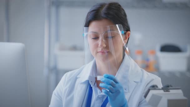 Female Lab Worker Wearing Ppe Face Shield Holding Test Tube — Stock Video
