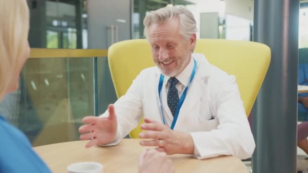 Two Medical Staff White Coat Scrubs Taking Break Talking Hospital — Stock Video