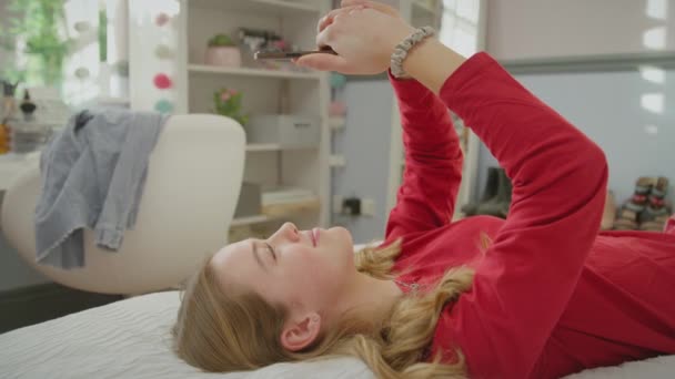 Teenage Girl Wearing Orthodontic Braces Lying Bed Home Talking Mobile — Stock Video