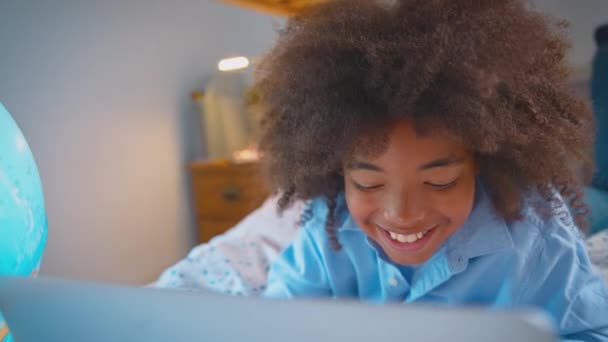 Pojke Sovrum Liggande Sängen Med Upplyst Glob Gör Läxor Laptop — Stockvideo