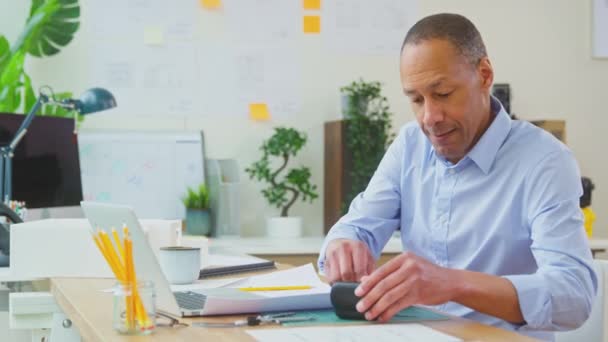 Male Architect Sitting Desk Putting Wireless Earbuds Listening Music Sitting — Stock Video