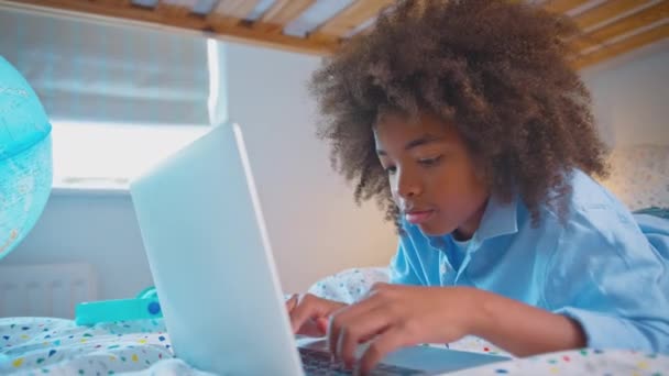 Chłopiec Sypialni Leżący Łóżku Oświetlonym Globusem Odrabiający Lekcje Laptopie Zastrzelony — Wideo stockowe