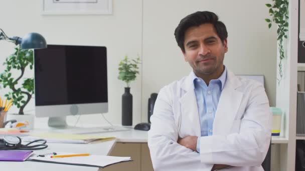 Portrait Smiling Male Doctor Wearing White Coat Thought Sitting Desk — Stock Video
