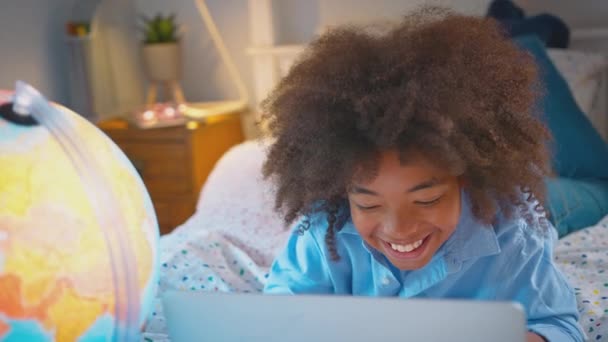 Portrait Boy Bedroom Lying Bed Illuminated Globe Doing Homework Laptop — Stock Video