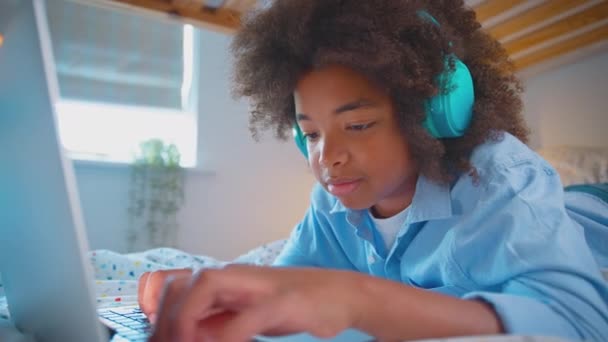 Boy Bedroom Lying Bed Wearing Wireless Headphones Listening Music Streaming — Stock Video