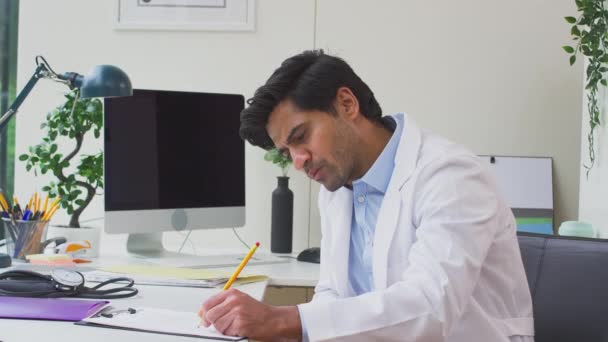 Médico Masculino Médico Cabecera Vestido Con Abrigo Blanco Sentado Escritorio — Vídeos de Stock