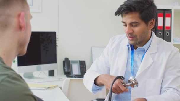 Portrait Smiling Male Doctor Stethoscope Wearing White Coat Standing Office — Stock Video