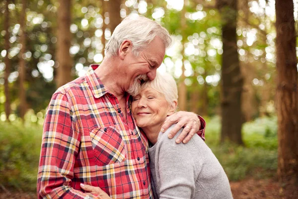 Loving Entired Senior Couple Hugging Walk Woodland Countryside Together — стоковое фото