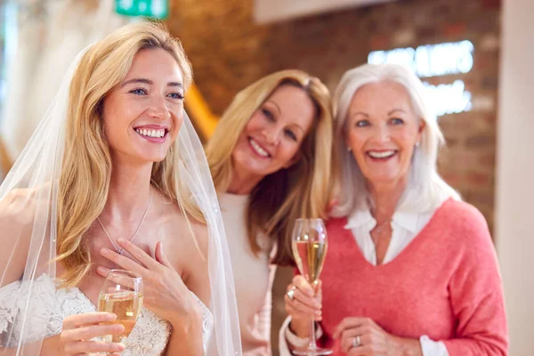 Grandmother Mother Watching Adult Daughter Choosing Trying Wedding Dress Bridal — Stockfoto