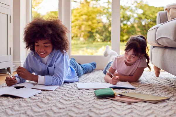 Boy Girl Lying Rug Lounge Home Doing School Homework Together — Stockfoto