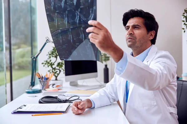 Male Doctor Wearing White Coat Sitting Desk Looking Mri Scan — Stock Photo, Image