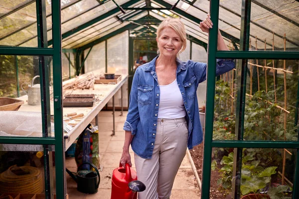 Portrait Mature Woman Watering Can Gardening Greenhouse Home — Foto Stock