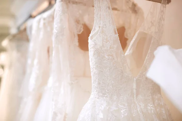 Close Beautiful Bridal Wedding Dresses Hanging Rail Shop — 图库照片