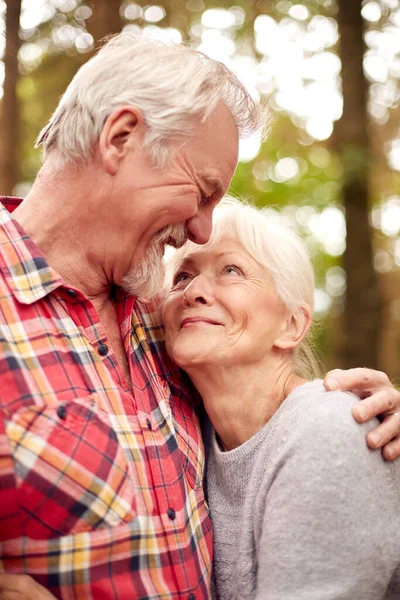 Loving Retired Senior Couple Hugging Walk Woodland Countryside Together — Stockfoto