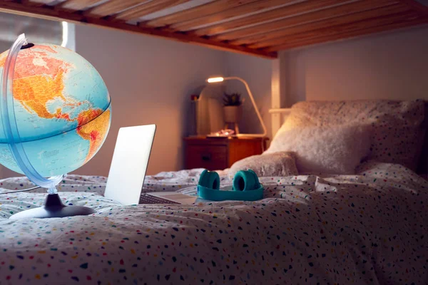 Inside Child\'s Bedroom At Night With Laptop Headphones And Globe On Bunk Bed