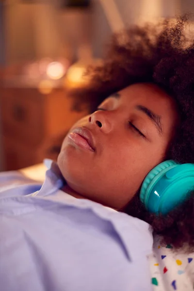 Boy Lying Bed Wearing Wireless Headphones Eyes Closed Listening Music — 图库照片
