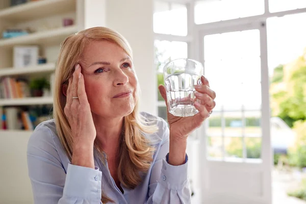 Menopausal Mature Woman Home Suffering Headache Pain Drinking Glass Water — Stock fotografie