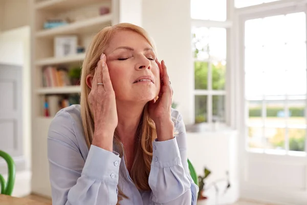 Menopausal Mature Woman Home Suffering Headache Pain Royaltyfria Stockbilder