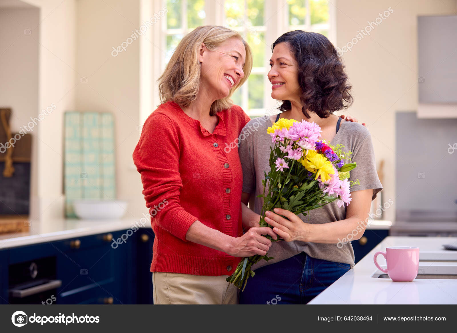 Loving Same Sex Mature Female Couple Kitchen Woman Giving Partner Stock Photo by ©monkeybusiness 642038494