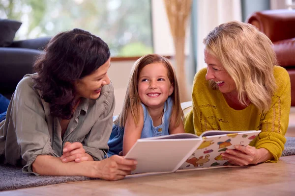 Same Sex Family Two Mature Mums Daughter Lying Floor Reading — Stock Photo, Image