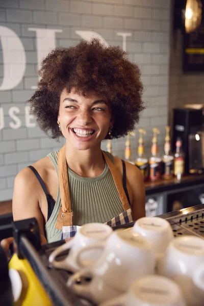 笑顔の女性オーナーやスタッフがコーヒーショップでカウンターの後ろでサービスを提供 — ストック写真