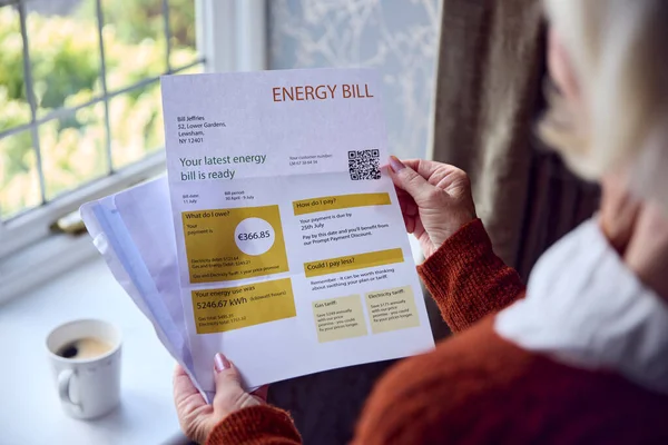 生活エネルギー危機のコストに関するユーロエネルギー法案を開くシニア女性の閉鎖 — ストック写真
