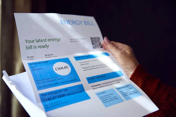 英国のエネルギー法案を開くシニア女性の閉鎖生活エネルギー危機のコストについて — ストック写真