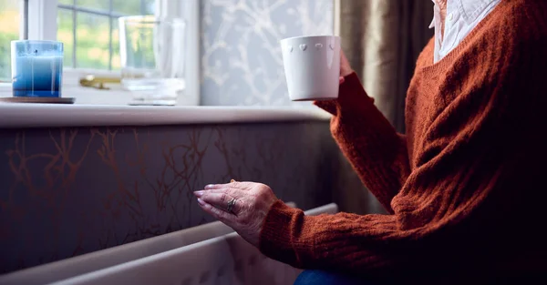 Starsza Kobieta Gorącym Napojem Próbuje Utrzymać Ciepło Przez Chłodnicę Domu — Zdjęcie stockowe
