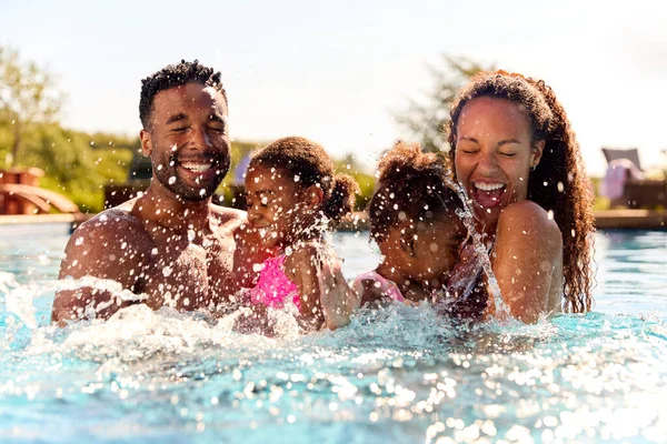 Family Summer Holiday Two Girls Being Held Swimming Pool Parents — 스톡 사진