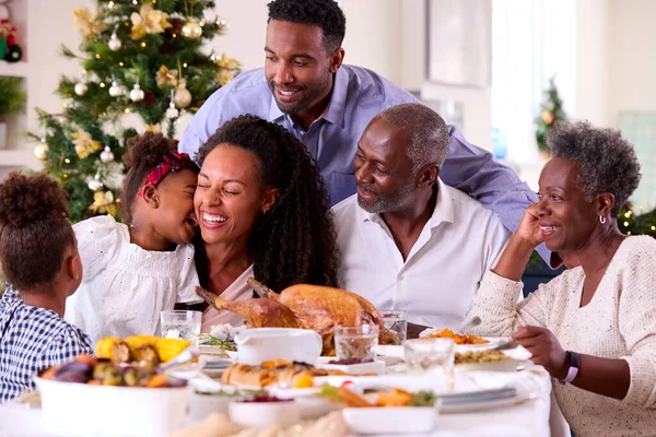 Multi Generation Family Celebrating Christmas Home Eating Meal Together Stock Image