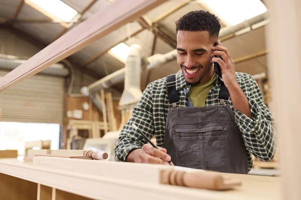 Male Apprentice Working Carpenter Furniture Workshop Making Phone Call — Stock Photo, Image
