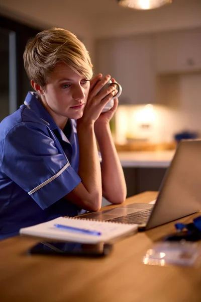 Tired Woman Wearing Medical Scrubs Working Studying Laptop Home Night — Stock Photo, Image