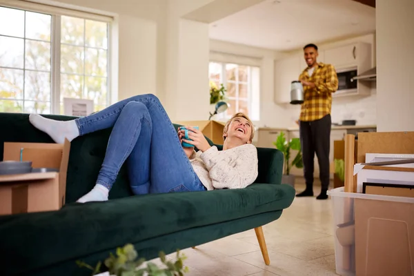 Couple Unpacking Boxes Moving New Home Together Woman Lies Sofa — Stock Photo, Image
