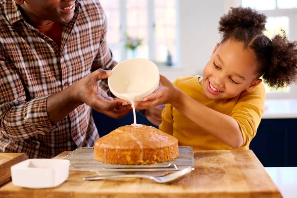 Baba Kızıyla Birlikte Mutfakta Pasta Pişirirken Çekilmiş Dondurmayla Süslenmiş Pasta — Stok fotoğraf