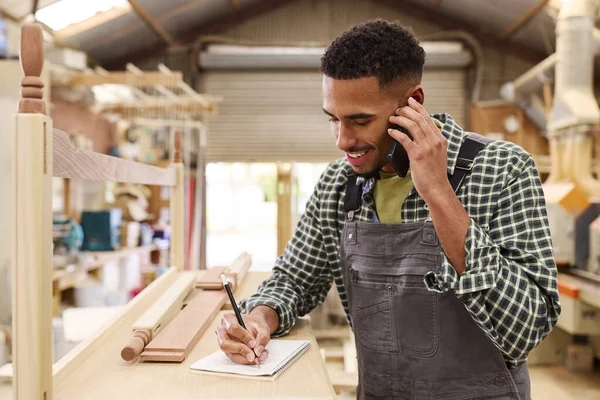 Male Apprentice Working Carpenter Furniture Workshop Making Phone Call — Stock Photo, Image