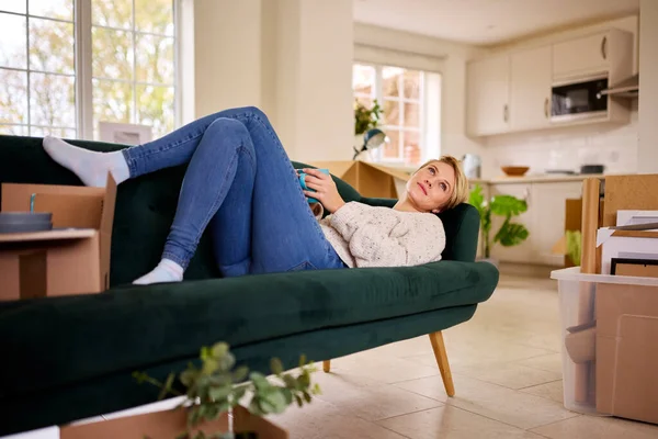 Woman Relaxing Sofa Dreaming Future Moving New Home — Stock Photo, Image